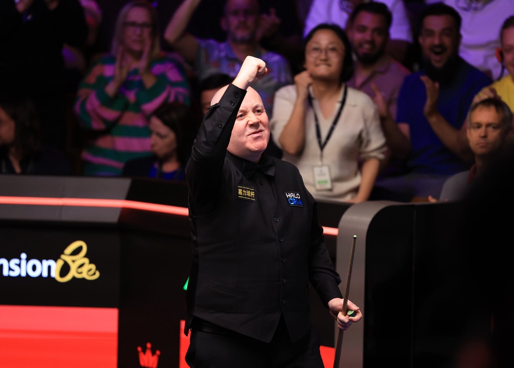 John Higgins celebrates victory over Ronnie O'Sullivan (PA)