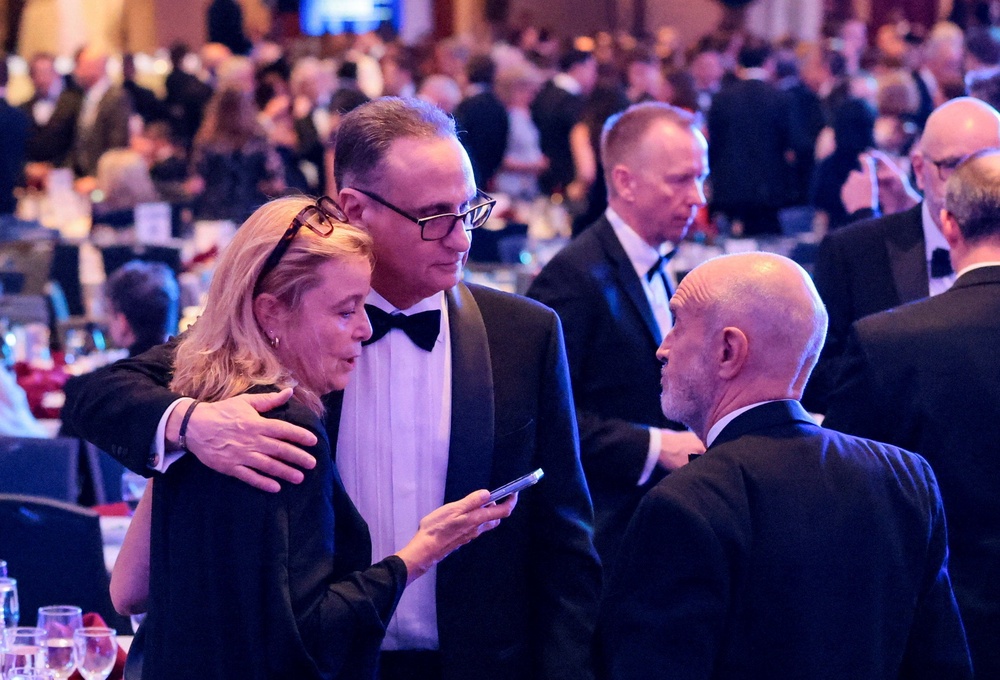 Journalists comforting one another on what proved to be a distressing evening for attendees (Reuters)