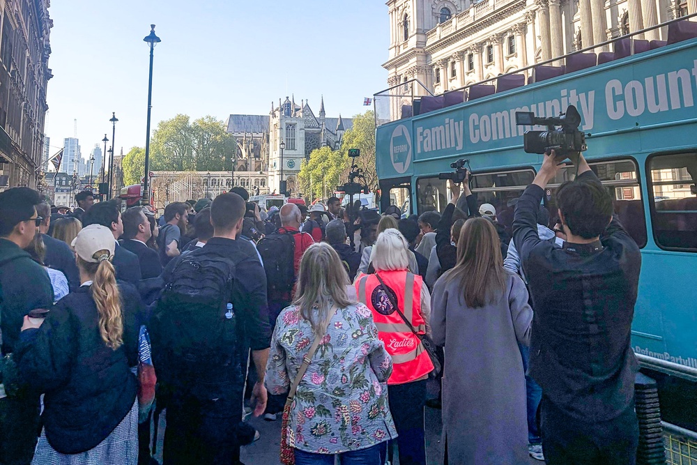 Only a handful of spectators gathered on the street by the bus, the majority from the media (The Independent)