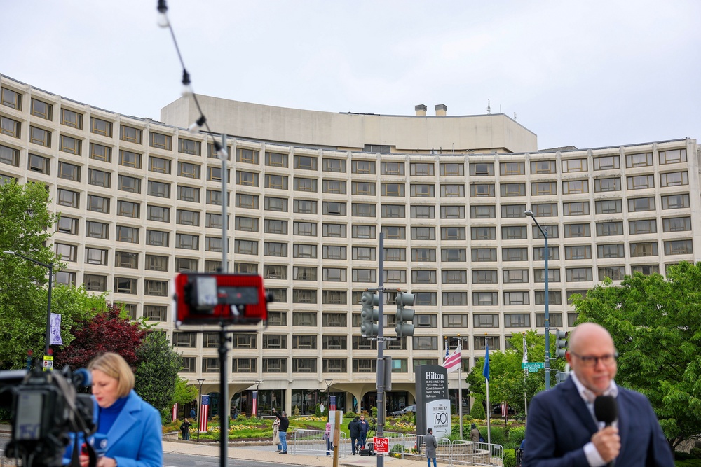 Journalists report outside the Washington Hilton hotel one day after an attempted attack inside against the annual White House Correspondents' Association dinner (Getty)