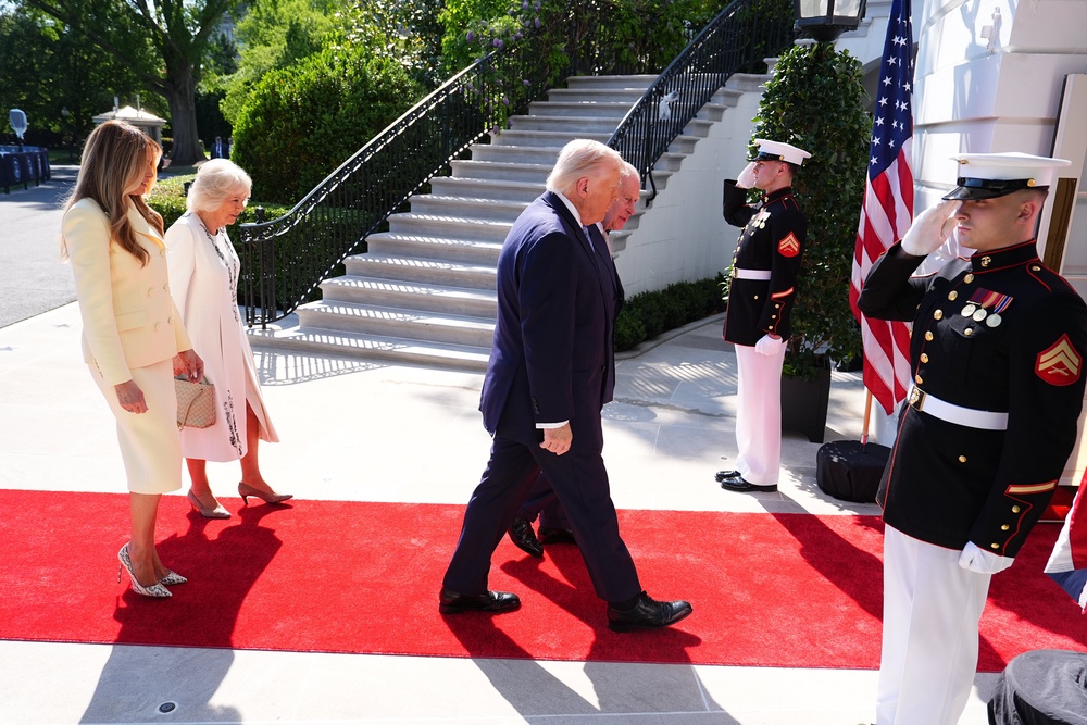 The King and Donald Trump are saluted by a US marine (Aaron Chown/PA) (PA Wire)