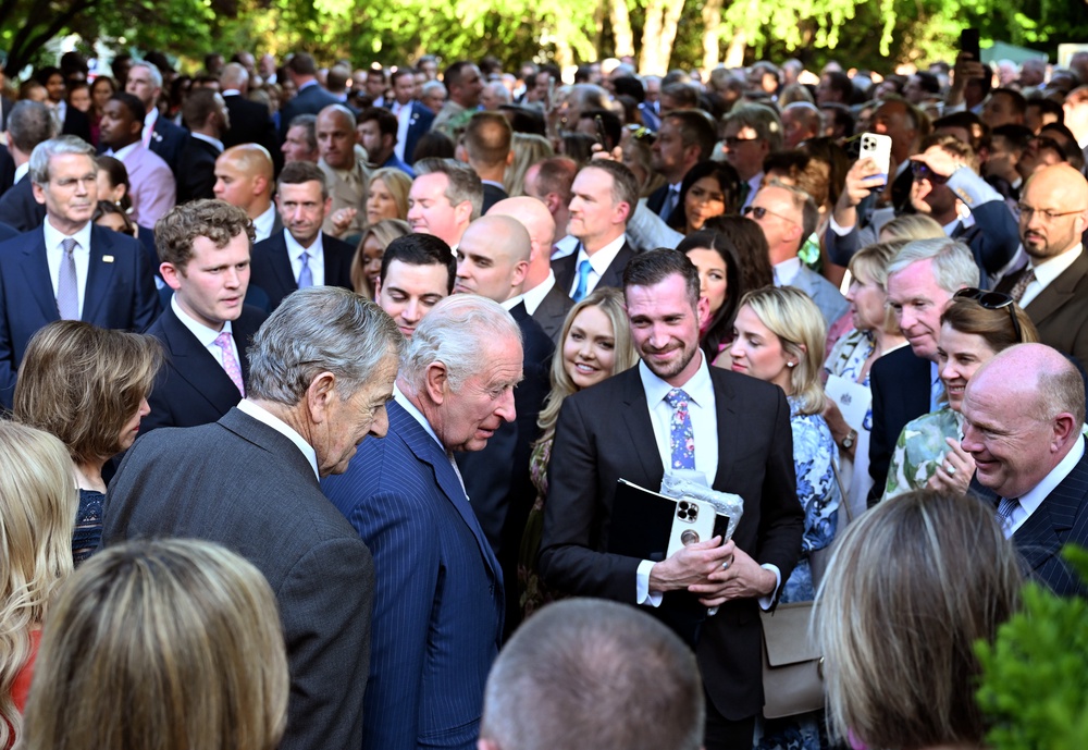 King Charles greets guests at a garden party at the British Embassy in Washington, D.C., Monday (Getty)