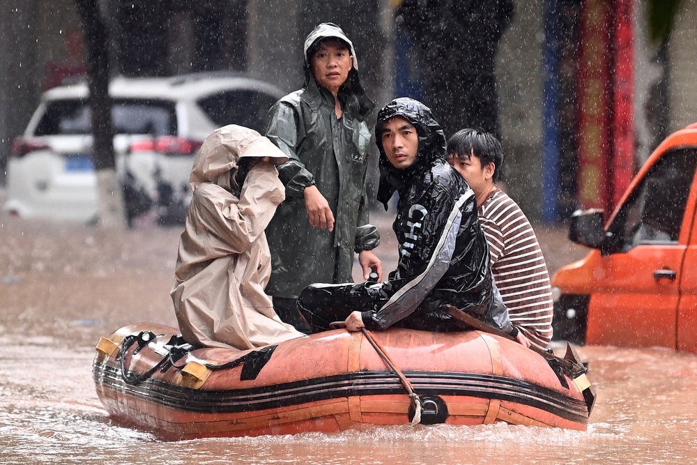 Stranded residents are evacuated on a boat after flooding from heavy rainfall in Qinzhou in southern China's Guangxi Zhuang Autonomous Region. (AP)