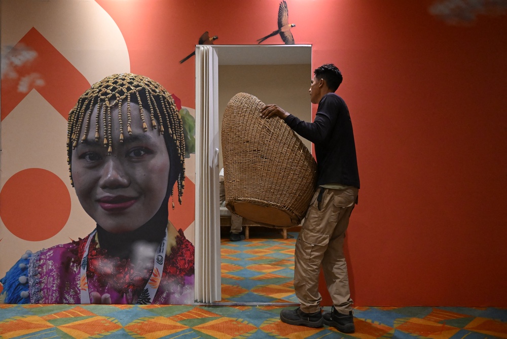 A worker carries a chair at the Estelar Convention Center during preparations ahead of the International Conference on the Just Transition Away from Fossil Fuels in Santa Marta, Colombia (AFP/Getty)