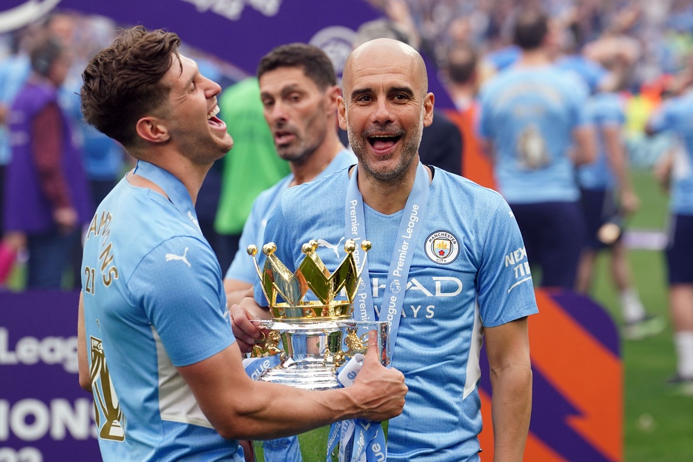 John Stones, left, and Pep Guardiola with the Premier League trophy (PA Archive)