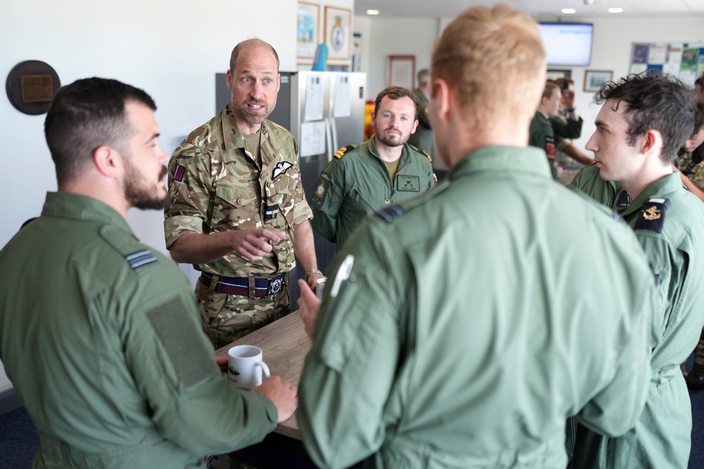 The Prince of Wales speaks to members of 202 Squadron (Dominic Lipinski/PA)