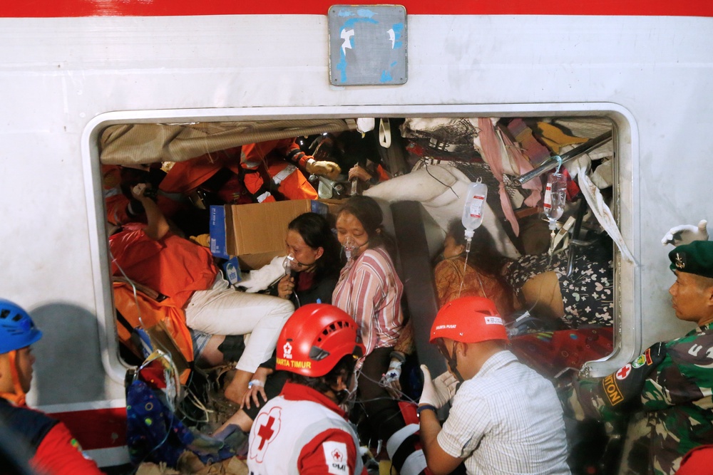 Passengers are seen being rescued after the train crash in Bekasi, Indonesia (AP)