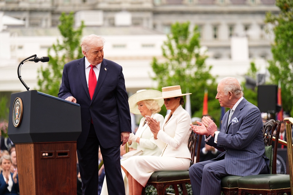 The King claps after Mr Trump turns back to look at him as he delivers a speech (Aaron Chown/PA) (PA Wire)