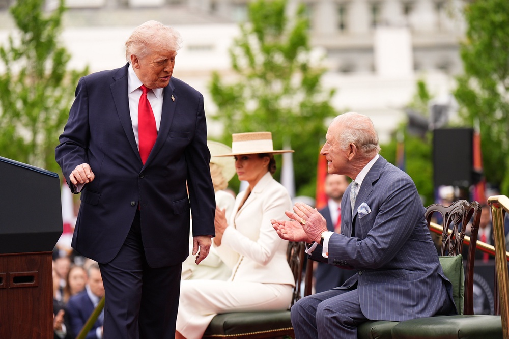 Charles claps after Donald Trump turns back to look at him as he delivers a speech (Aaron Chown/PA) (PA Wire)