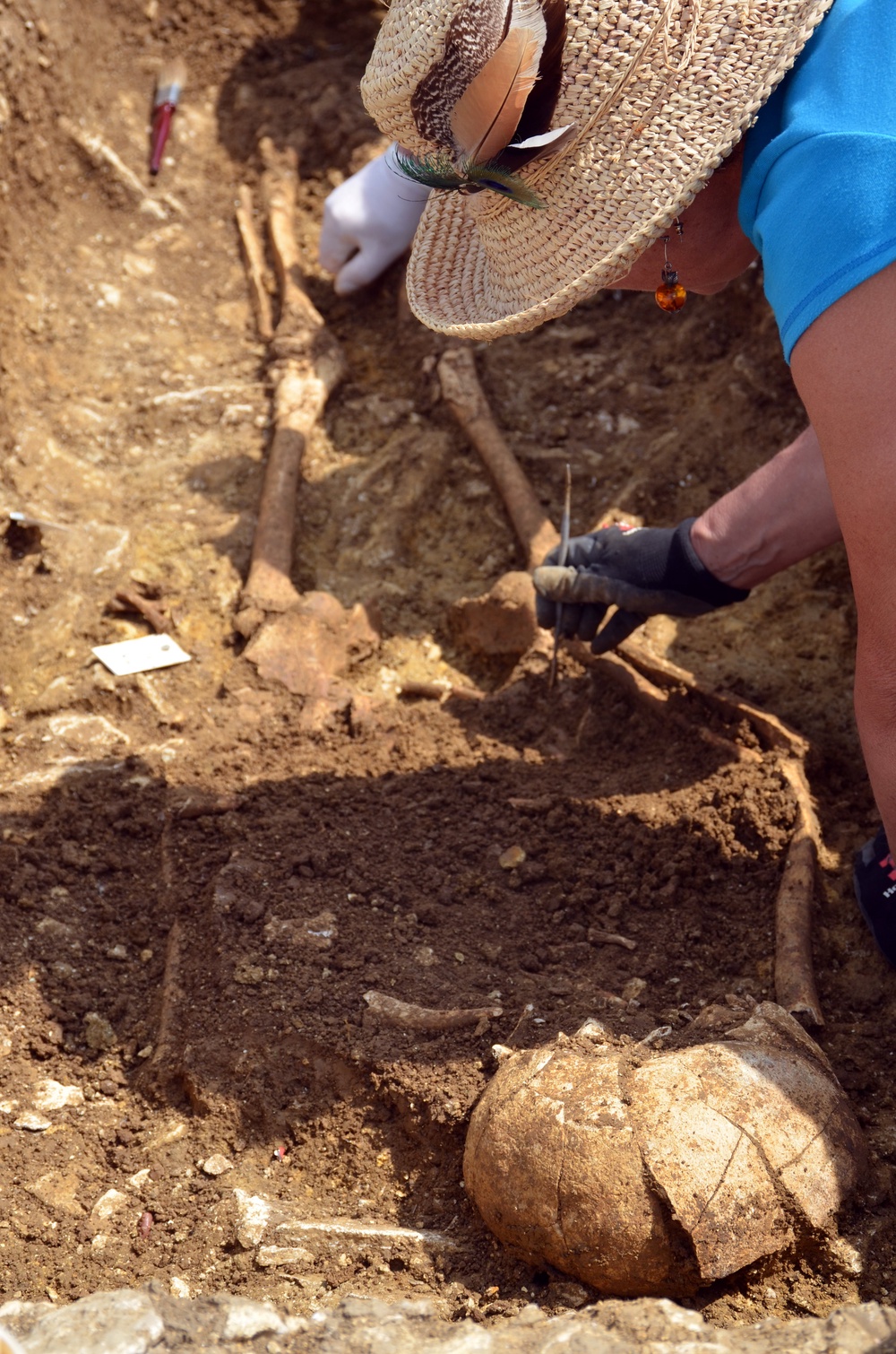 A volunteer painstakingly uncovers one of the Anglo-Saxon burials (Cotswold Archaeology)