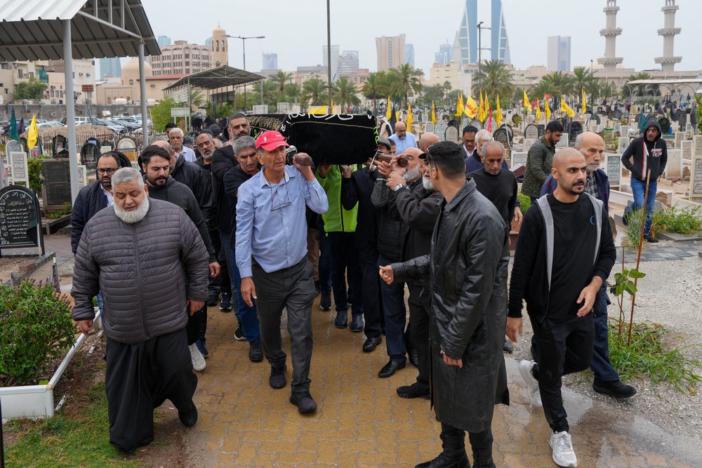 People carry the coffin of a person killed during a drone attack on a high-rise apartment building in Bahrain's capital Manama to its grave during the burial on 10 March 2026 (AFP/Getty)