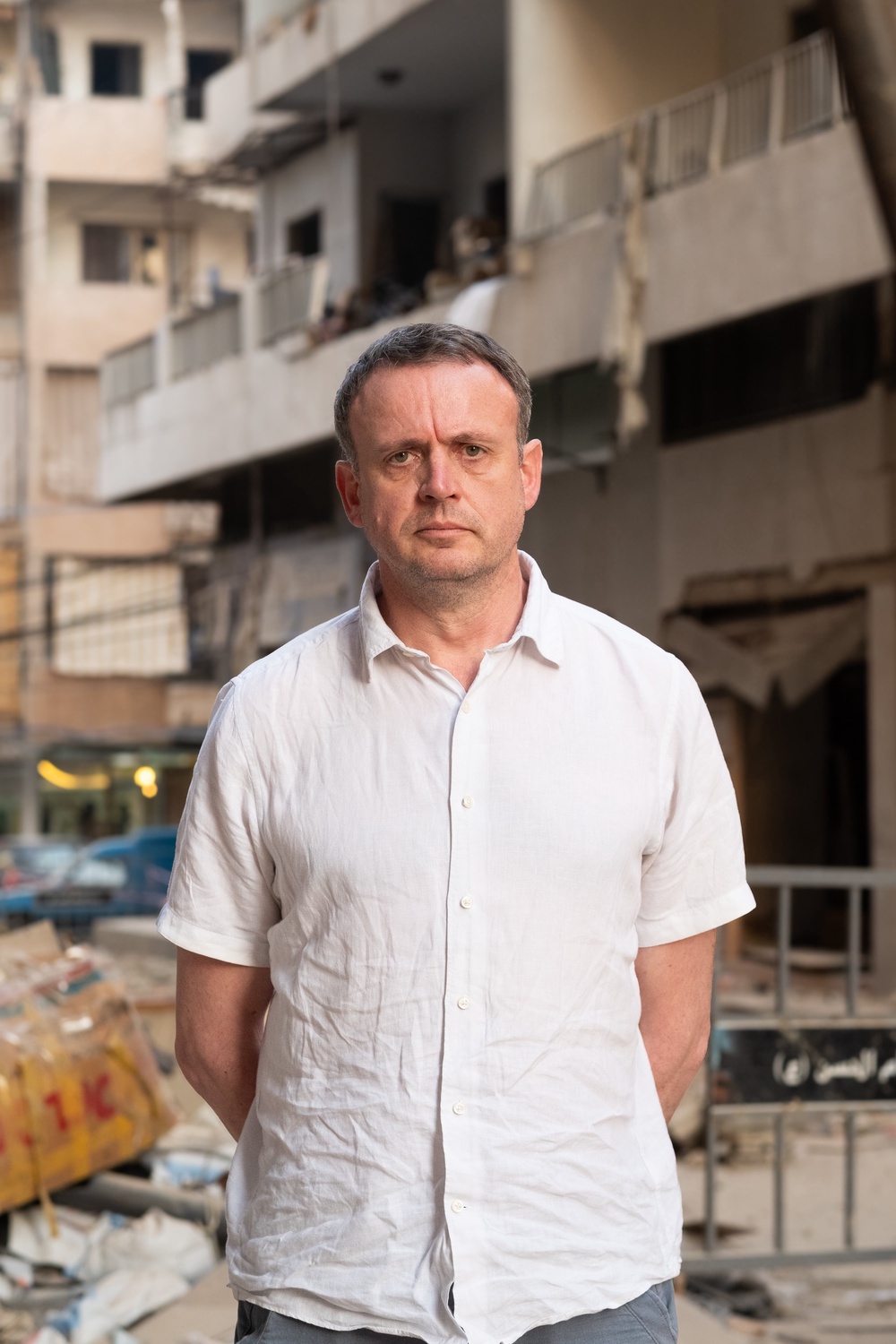 Christian Aid CEO Patrick Watt is photographed in front of a building destroyed by Israeli airstrikes in Beirut (Amy Sheppey/Christian Aid)