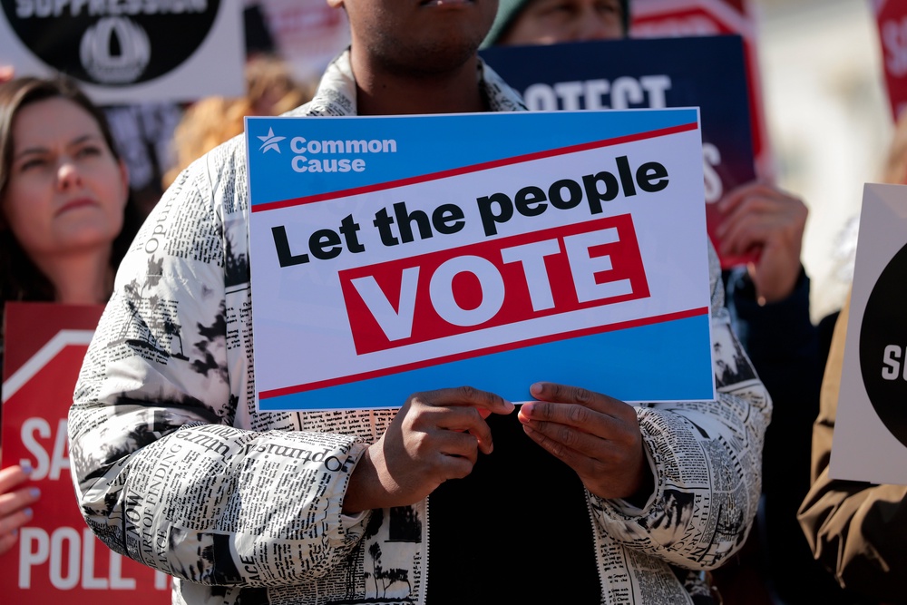 Attendees hold signs advocating for voting rights and against the SAVE America Act at a rally to outside the U.S. Capitol on March 18 (Getty)