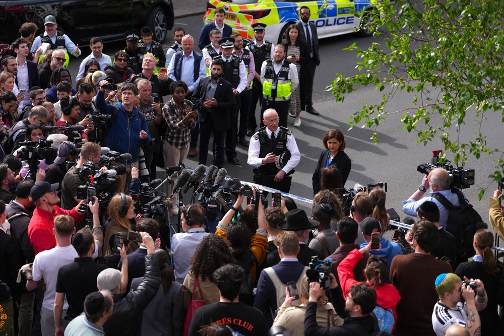 Sir Mark Rowley and Sarah Sackman MP being heckled by crowds (Getty)