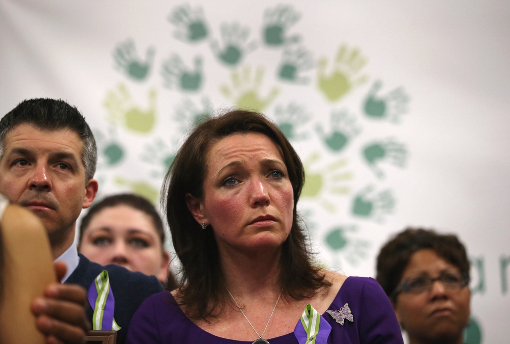 Nicole and Ian Hockley, parents of Sandy Hook massacre victim Dylan Hockley, listen during a press conference with fellow parents of victims on the one month anniversary of the Newtown elementary school massacre on January 14, 2013 in Newtown, Connecticut (Getty Images)