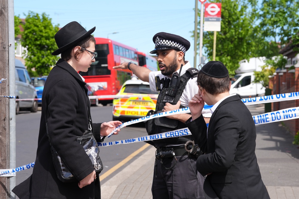 Police officers at the scene in Golders Green, north-west London, after two men – one aged 76 and another aged 34 – were stabbed on Wednesday morning (Lucy North/PA) (PA Wire)