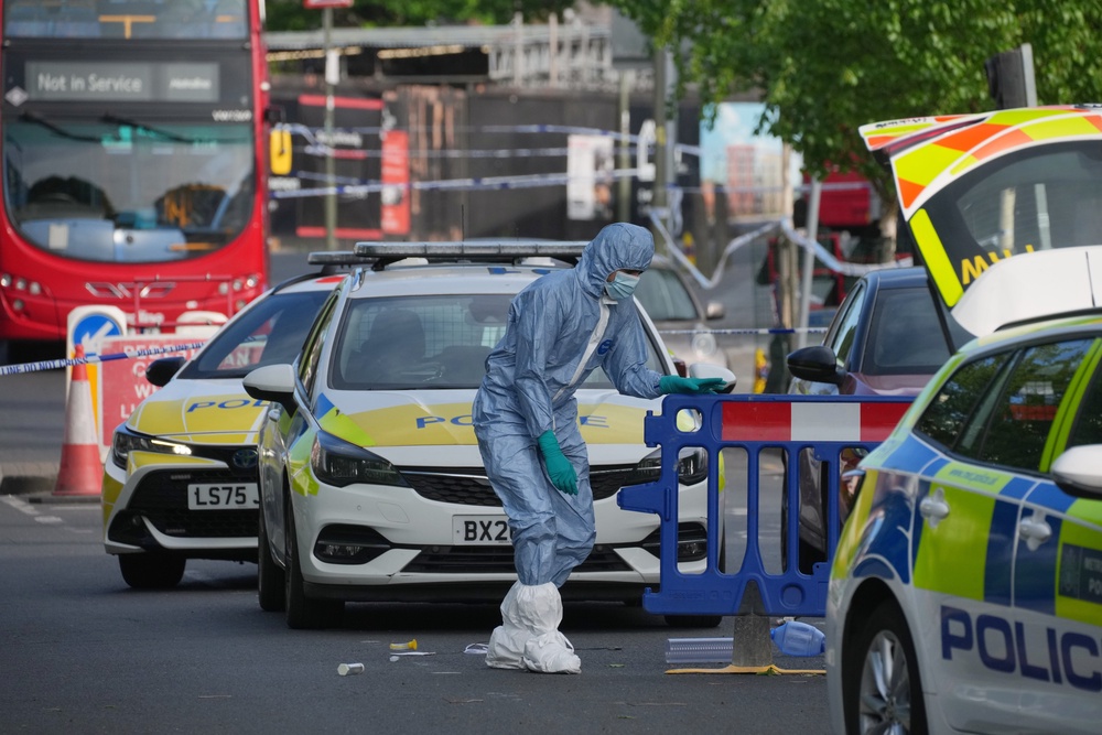 Forensic officers at the scene in Golders Green (AP)
