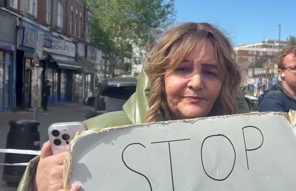 Ambrosine Shitrit with a sign reading 'stop the attack on Jews' (Camille Chorley)