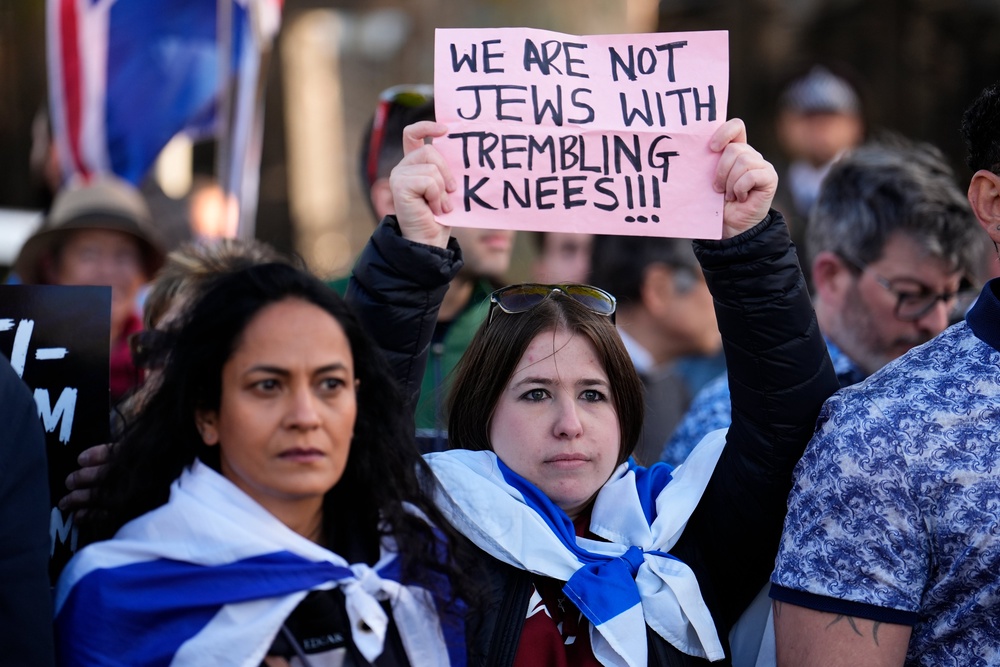 People protest near the scene in Golders Green (PA)