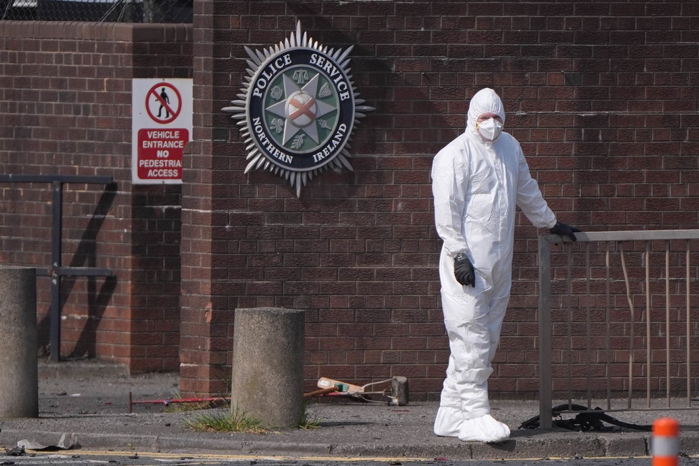 A forensic investigator at the scene in Dunmurry after a car exploded outside a police station (Niall Carson/PA) (PA Wire)