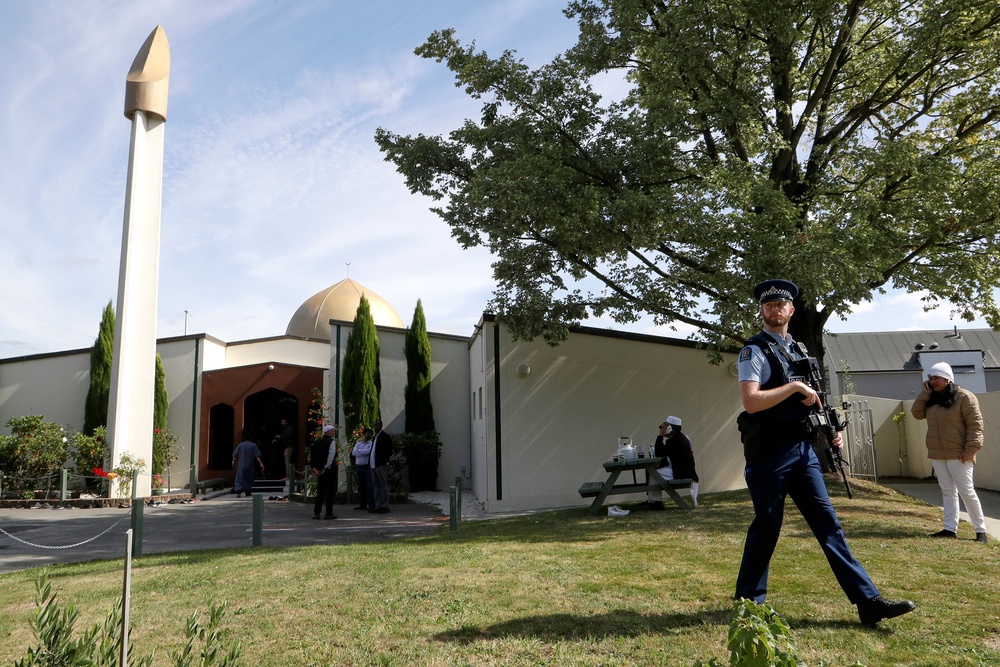 An armed policeman patrols the grounds at the Al Noor mosque following the attack (AP)