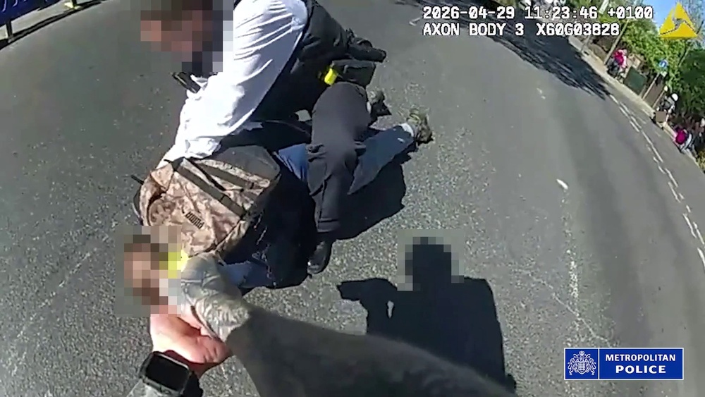 Footage from body-worn cameras shows the suspect being tasered and pinned to the ground as officers tried to pull the knife from his hand (Metropolitan Police/PA) (Metropolitan Police)