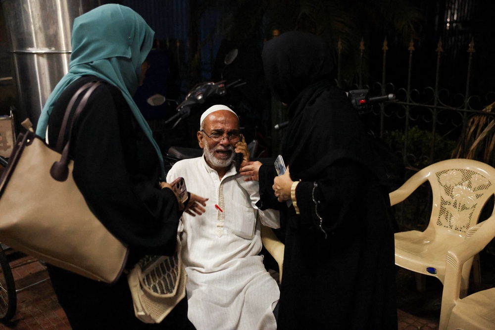 A man weeps outside an emergency room after compound wall of a hospital collapsed following rains in Bengaluru (Reuters)