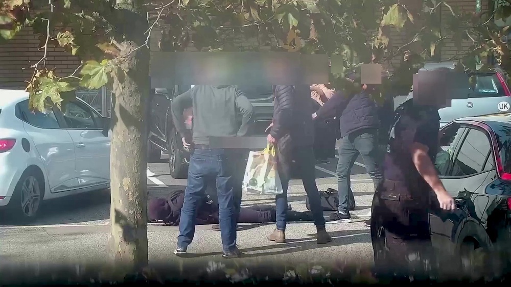 Screen grab taken from video dated 29/09/23 issued by the Metropolitan Police showing Alfie Coleman lying on the ground as he is surrounded by armed officers in a Morrisons car park, moments after picking up a handgun and around 200 rounds of ammunition from undercover agents on September 29 2023 (PA)