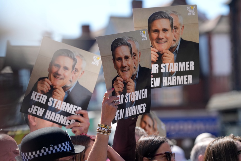 Protesters held signs reading 'Keir Starmer Jew harmer' (AP)