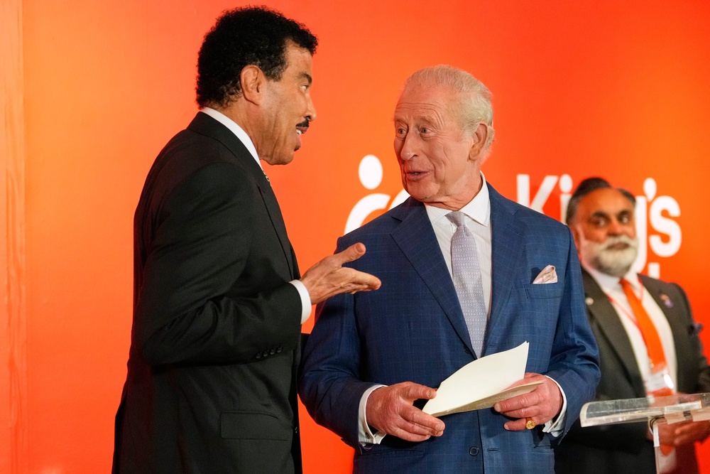 The King was joined on stage by Lionel Richie as he delivered his speech (AP)