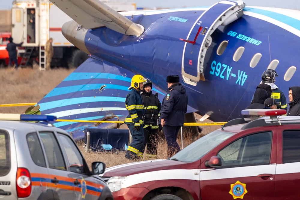 Emergency specialists work at the crash site of an Azerbaijan Airlines passenger jet near the western Kazakh city of Aktau on December 25, 2024 (AFP/Getty)