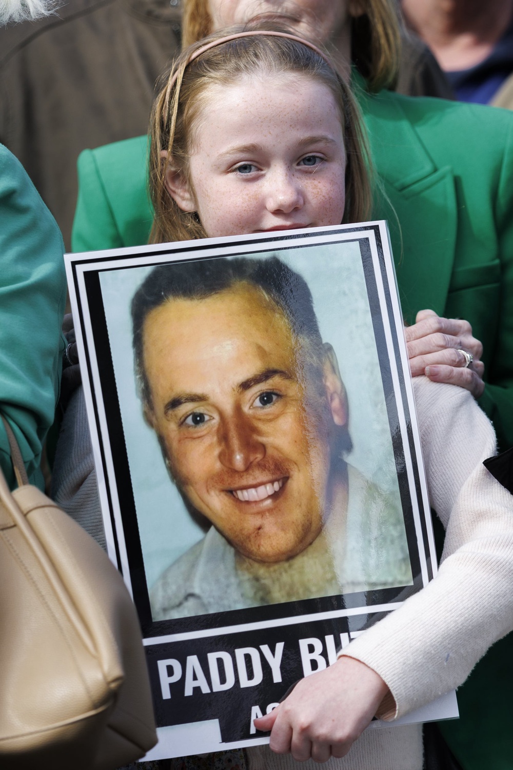 Sophie Butler Brady holds a picture of her grandfather Paddy Butler, outside Belfast Coroner’s Court (Liam McBurney/PA) (PA Wire)