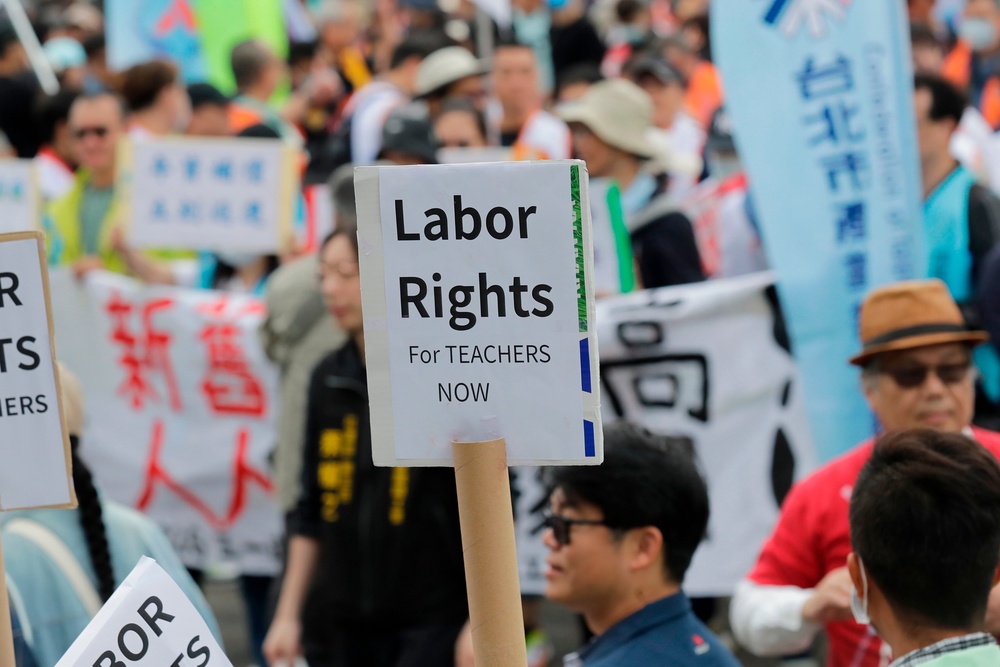 People take part in a May Day rally in Taipei, Taiwan, (AP)