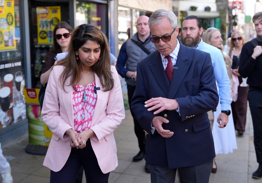 Nigel Farage and Suella Braverman during a walkabout in Waterlooville, Hampshire, on the campaign trail for the upcoming local elections (PA)