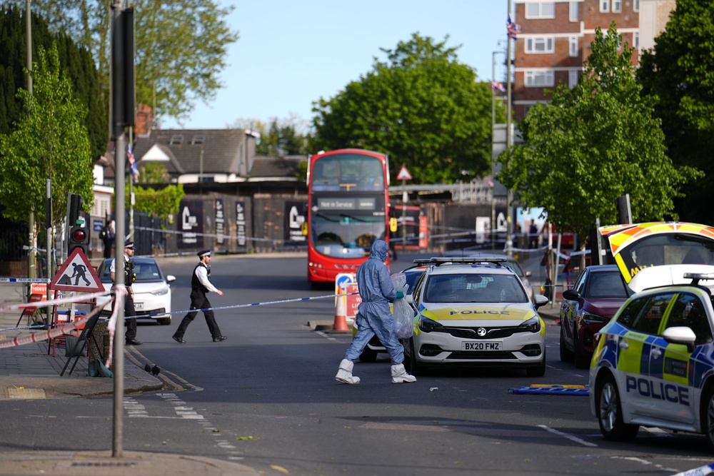 A forensics officer at the scene in Golders Green (PA)