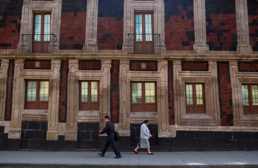 Pedestrians walk past a slightly tilted historic building in downtown Mexico City, June 15, 2016 (Copyright 2016 The Associated Press. All rights reserved.)