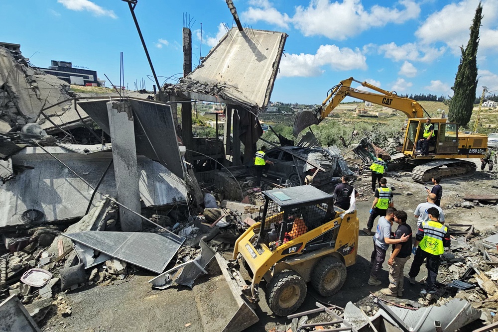 First responders search for survivors amongst the rubble at the site of an Israeli airstrike that targeted the southern Lebanese village of Ain Baal on May 1 (AFP/Getty)