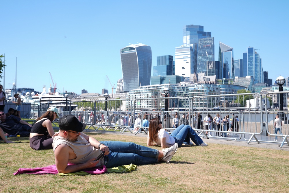 People relax in the hot weather in Potters Fields Park, London (Lucy North/PA) (PA Wire)
