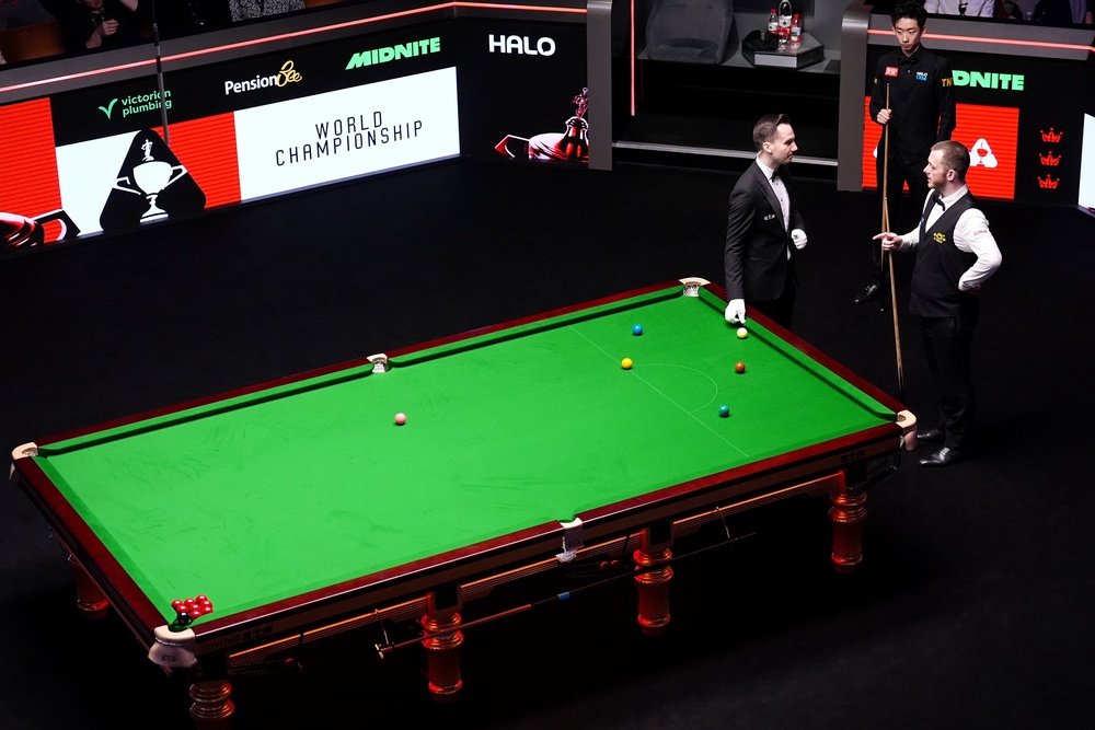 The referee discusses the situation with Mark Allen (PA)