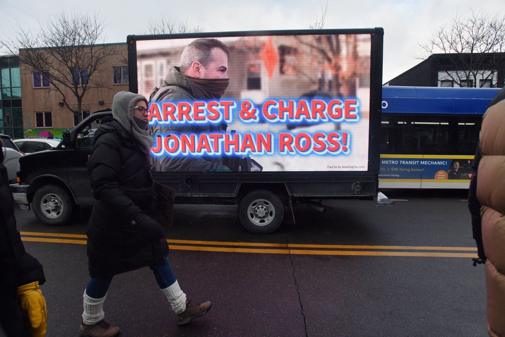 Democratic lawmakers are outraged that immigration agent Jonathan Ross, shown here on an electronic billboard in Minneapolis in January, has been reinstated and reassigned outside Minnesota (AFP/Getty)