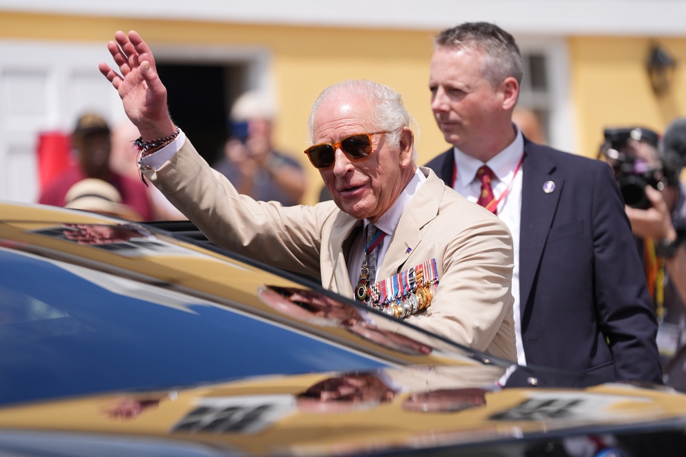 The King waves to well-wishers during a ceremonial welcome (Yui Mok/PA) (PA Wire)