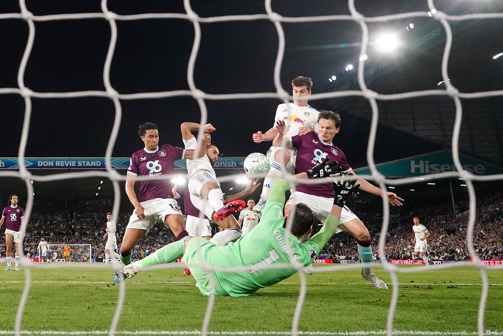 Dominic Calvert-Lewin, second left, stretches to score Leeds’ third goal (Martin Rickett/PA) (PA Wire)