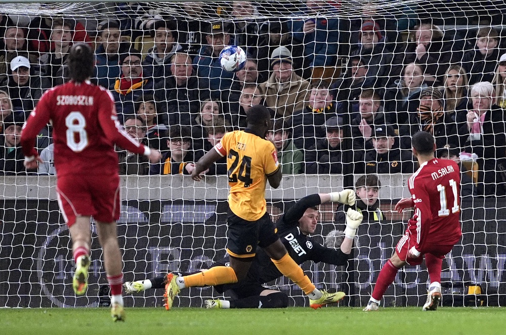Mohamed Salah, right, scores against Wolves (Peter Byrne/PA) (PA Wire)