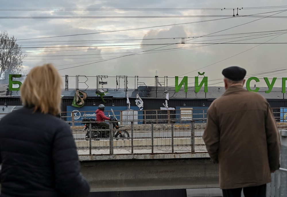 Residents stand near the site of a Russian drone strike in Ternopil, Ukraine (Reuters)