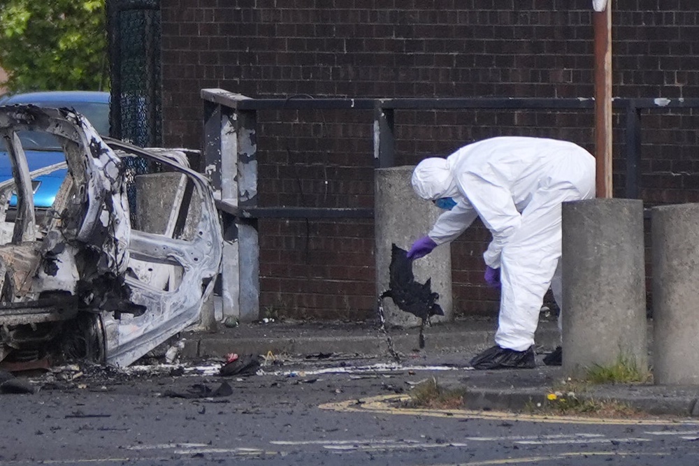 Forensic investigators at the scene in Dunmurry (Niall Carson/PA) (PA Wire)