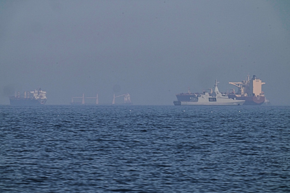 An Emirati patrol boat, second from right, is near a tanker anchored in the Gulf of Oman near the Strait of Hormuz (AP)