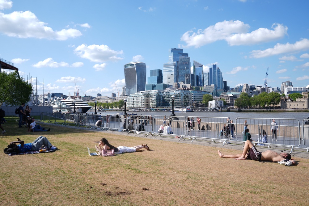 People relaxing in the hot weather in Potters Fields Park, London (PA)