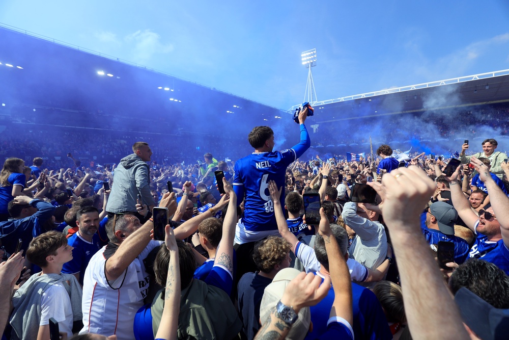 Fans swarmed onto the pitch to celebrate at Portman Road (PA)