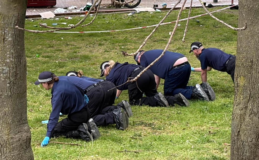 Police searching near the scene after four people were taken to hospital with gunshot wounds (Clara Margotin/PA Wire)