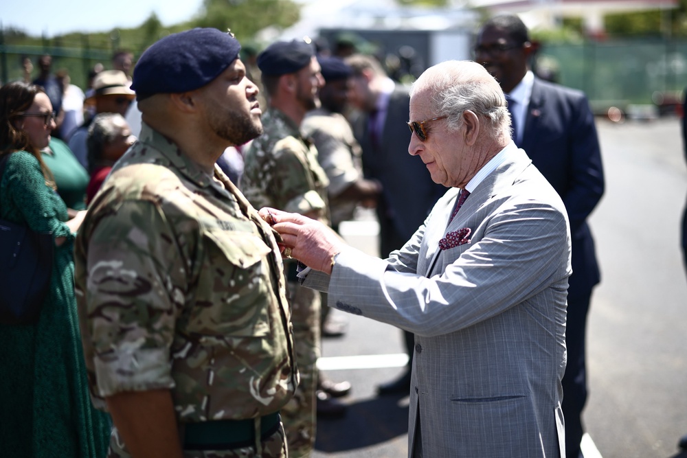 Charles presents an Operational Service Medal to members of the military during his visit to St David’s, Bermuda (Henry Nicholls/PA) (PA Wire)